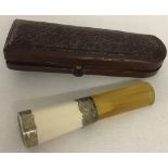 An antique, cased, silver collared cheroot holder.