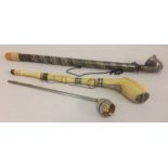 3 long handled pipes. An antique ivory smoking pipe with silver collars and panel to top of bowl.
