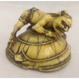 A 19th century Japanese ivory netsuke of an Oni capturing Shoki the demon queller's sword.