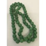 A string of green jade beads.