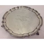 A claw and ball, 3 footed silver salver with inscription. Hallmarked Birmingham, 1965.