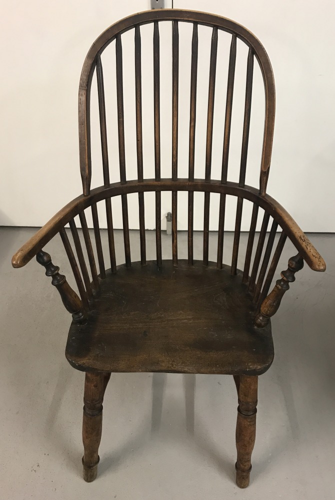 A Georgian hoop back Windsor chair with turned legs and front arm supports.