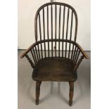 A Georgian hoop back Windsor chair with turned legs and front arm supports.