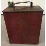 A vintage red Shell petrol can. Logo to top.