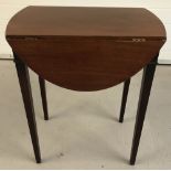 A vintage mahogany drop leaf occassional table raised on square tapered legs.