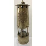 A vintage brass miners safety lamp "The Protector", with name plate.