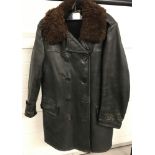 A vintage black leather motorcycle 3/4 coat with brown faux fur collar.