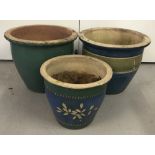 A collection of 3 blue and green glazed garden planters.