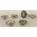 6 silver and white metal dress rings.