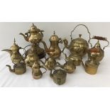 A collection of 13 miniature and ornamental brass tea and coffee pots.