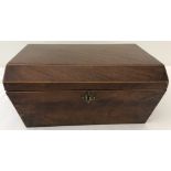 A vintage sarcophagus shaped box with shaped brass escutcheon and paper lining to interior.