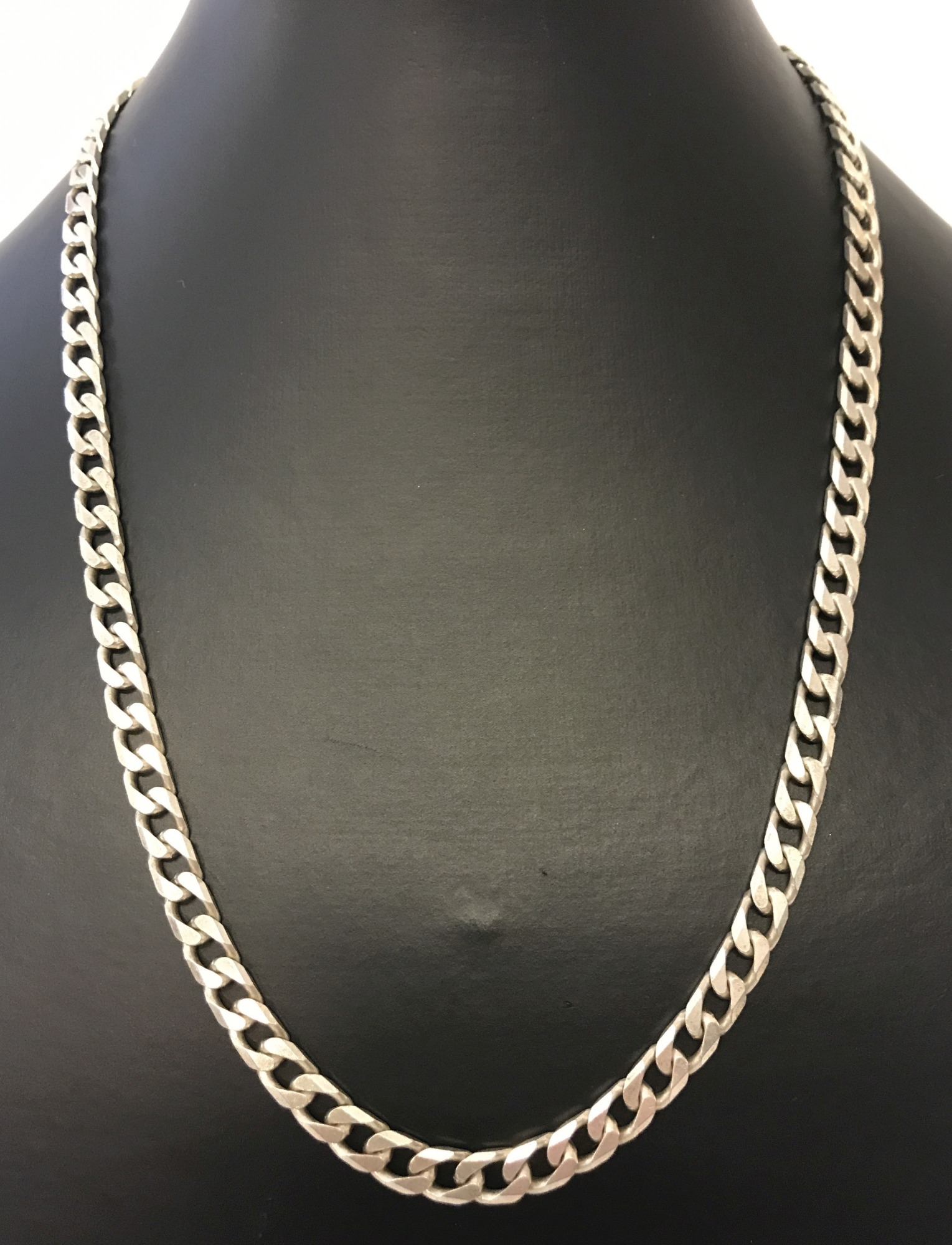 A heavy 18 inch silver curb chain.