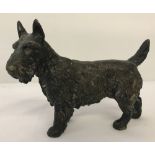 A bronze figure of a Scottish Terrier dog.