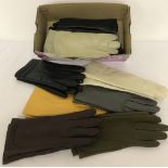 A box of 12 pairs of ladies vintage synthetic gloves in varying colours.