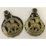 2 vintage large horse brasses on leather straps depicting an elephant and castle.