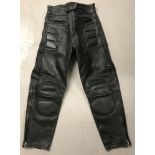 A pair of "Stanz" black leather motorcycle trousers with padded knees, thighs and hips.