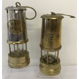 2 vintage brass miners lamps with name plates, one with stainless steel finish.