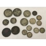 A collection of antique silver and bronze coins.