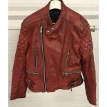 A vintage red leather biker jacket by "Sportex".