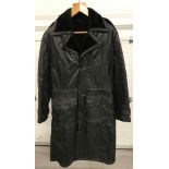 A vintage full length men's black leather coat with faux fur lining.