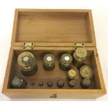 A light wood box containing a quantity of brass weights to include Avery.