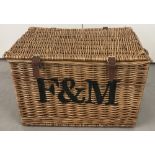 A Fortnum & Mason extra large luxury wicker hamper with fastening straps and carrying handles. .