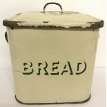 A vintage cream and green enamel bread bin.