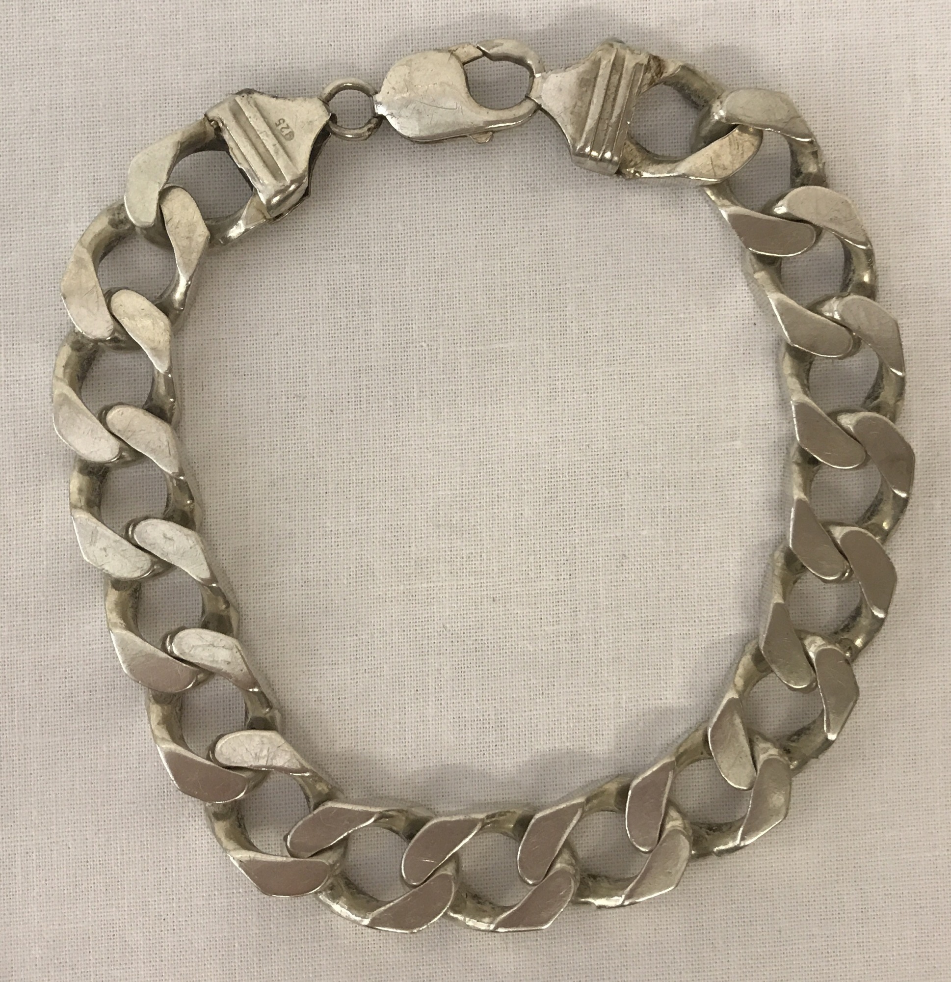 A heavy curb chain bracelet marked 925.