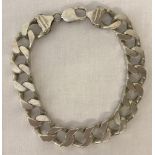 A heavy curb chain bracelet marked 925.
