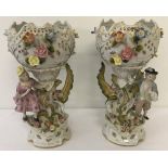 A pair of large ceramic ornamental urns with flower and figure detail.