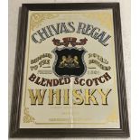 A Chivas Regal Blended Whisky advertising mirror with wooden frame.