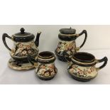 A Victorian ceramic lustreware tea set with hand painted floral design and gilt detail.