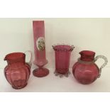 4 large items of cranberry coloured glass.