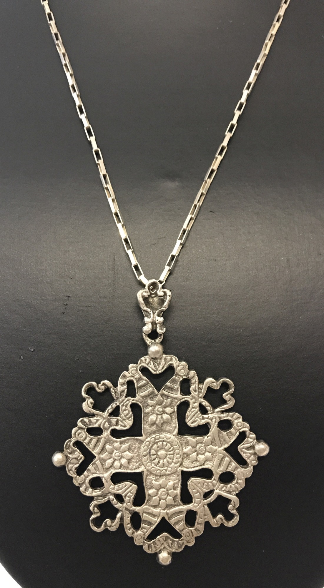 A large decorative pendant by Peruzzi on a 925 silver 24 inch box chain.
