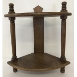 A vintage medium oak 2 tier corner shelf with turned detail to columns.