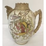 An antique Royal Doulton Burslem blush hand painted jug with floral decoration and gilt detail.