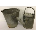 A vintage galvanised bucket together with a 1 gallon watering can complete with rose.