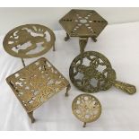 A collection of 5 vintage brass trivets.