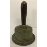 A vintage hand made brass bell with wooden handle.
