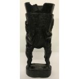 A heavy carved dark wood tribal urn. Carved detail of two tribal figures holding a cup/vessel.