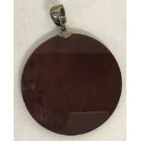 A large circular, modern design, deep burgundy natural stone pendant with push claps fixing bale.