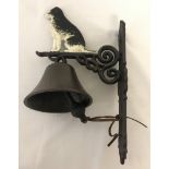 A painted cast iron, wall hanging garden bell with Collie dog detail.