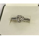 A 925 silver shimmering knot ring by Pandora. Marked to inside of band "S925 Ale 56".