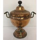 A vintage copper samovar with brass tap and handles.