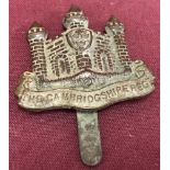 A WW1 Cambridgeshire regiment cap badge, letter e missing from middle of name.