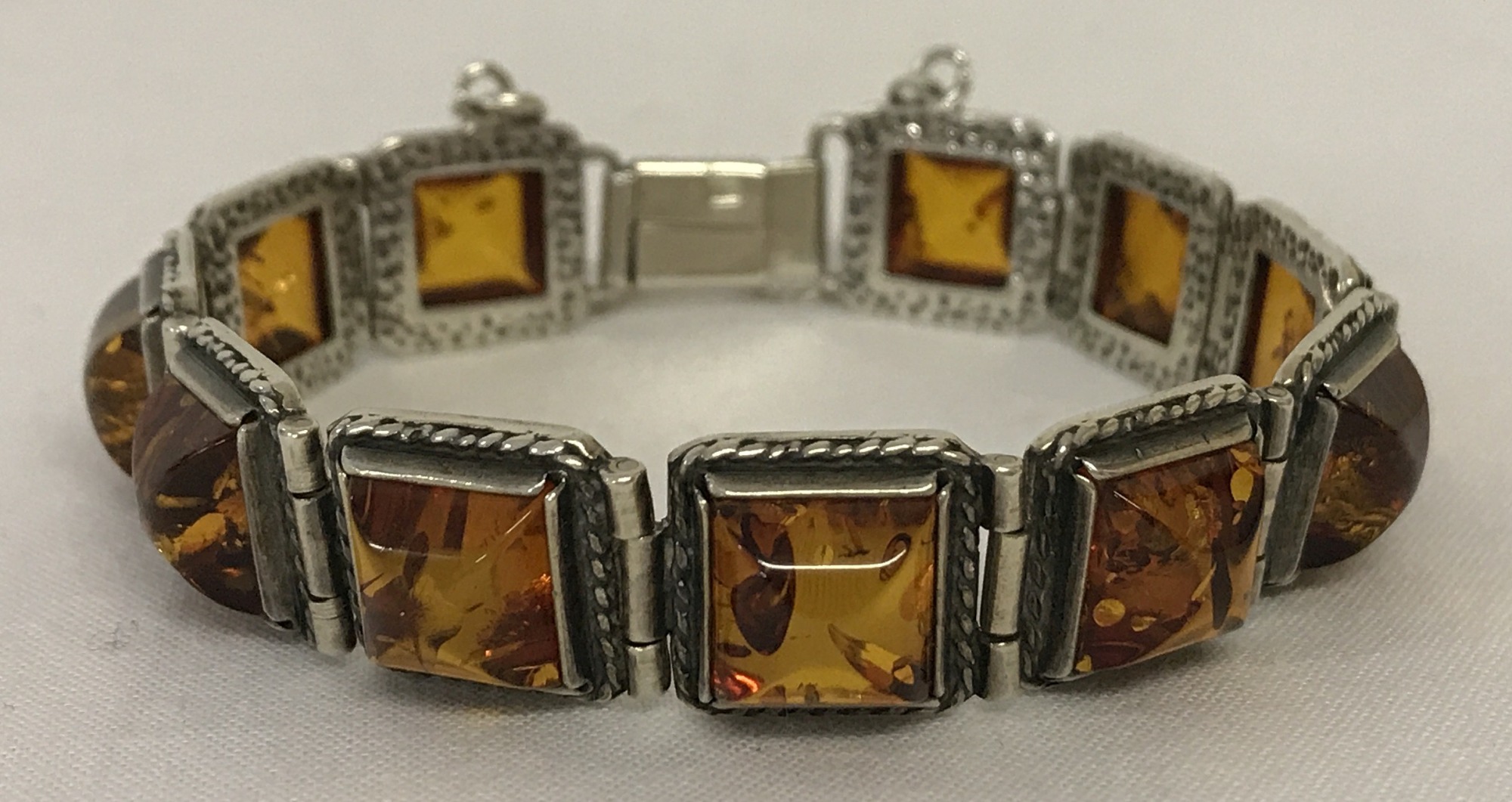 A 925 silver modern design square link bracelet set with Baltic amber.