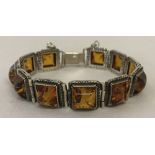 A 925 silver modern design square link bracelet set with Baltic amber.