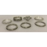 A collection 7 silver and white metal clear stone set rings.
