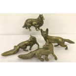 3 heavy brass figurines of foxes together with a dog.