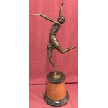 A large Art Deco style bronze figurine mounted on circular marble plinth.